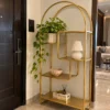 Aurelia Arc arched cosmetic display rack with gold frame and asymmetrical shelves