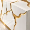 Aurelia Flow gold inlay console table with white cabinet storage and abstract gold detailing