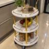 Aurelia Round marble serving trolley with white surfaces and gold frame
