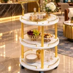 Aurelia Round marble serving trolley with white surfaces and gold frame