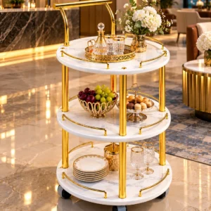 Aurelia Round marble serving trolley with white surfaces and gold frame