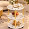Aurelia Round marble serving trolley with white surfaces and gold frame