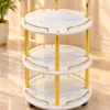 Aurelia Round marble serving trolley with white surfaces and gold frame