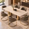Aureon Luxe marble dining table with gold pedestal base and upholstered chairs