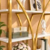 Aurevia curved frame cosmetic display rack with gold frame and white shelves