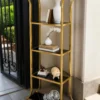 Aurevia Luxe gold multi tier display rack with open shelves and curved frame