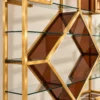 Aurex Geo geometric cosmetic display rack with gold frame and amber accents