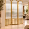 Aveline Arch three-panel fluted glass partition with gold frames and arched tops