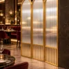 Aveline Arch three-panel fluted glass partition with gold frames and arched tops