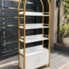 Elara Arch Luxe arched cosmetic display cabinet with gold frame and lower storage