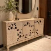 Florina floral carved console table with three decorative front panels and a light natural finish
