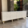Liora Carve white TV unit with four patterned doors and gold-tone leg accents