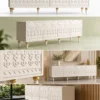 Liora Carve white TV unit with four patterned doors and gold-tone leg accents