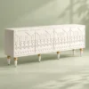Liora Carve white TV unit with four patterned doors and gold-tone leg accents