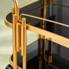 Orlena Luxe rounded edge serving trolley with gold frame and black serving surfaces