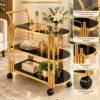 Orlena Luxe rounded edge serving trolley with gold frame and black serving surfaces