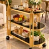 Orlena Luxe rounded edge serving trolley with gold frame and black serving surfaces