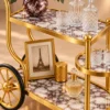 Regalia Wheel designer serving trolley with gold frame and large spoked wheel
