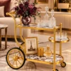 Regalia Wheel designer serving trolley with gold frame and large spoked wheel