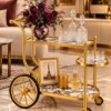 Regalia Wheel designer serving trolley with gold frame and large spoked wheel