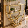 Velora hourglass cosmetic display rack with curved gold frame and three open shelves