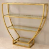 Velora hourglass cosmetic display rack with curved gold frame and three open shelves