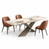 Veyra Cross marble dining table with dark sculptural base and four upholstered chairs