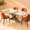 Veyra Cross marble dining table with dark sculptural base and four upholstered chairs