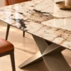 Veyra Cross marble dining table with dark sculptural base and four upholstered chairs