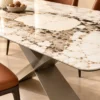 Veyra Cross marble dining table with dark sculptural base and four upholstered chairs