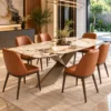 Veyra Cross marble dining table with dark sculptural base and four upholstered chairs