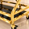 Xavia Luxe diamond frame serving trolley with gold structure and black serving surfaces
