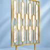 Hexara geometric PVD room partition with gold stainless steel frame and marble-look inserts