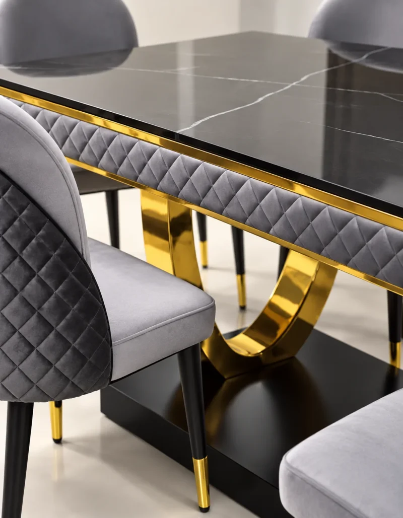 Close up of black marble dining table and gold U shaped stainless steel base