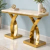 Luxury marble console table with two gold X-shaped bases against blue wall