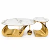 Aurelia marble centre table set of 2 with large oval and small round white marble tops on sculptural gold stainless steel bases.