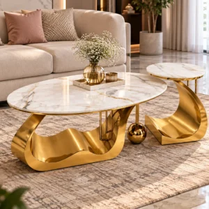 Luxury marble centre table set of 2 with gold curved bases styled on a rug in front of a beige living room sofa.