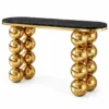Aureon Luxe black marble console table with gold stainless steel edging and two sculptural stacked sphere leg supports on white background.