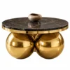 Aurevian luxury round black marble centre table with polished gold stainless steel spherical base on white background.
