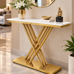 Gold stainless steel console table with white marble top, geometric crossed rod base and decorative vase beneath a circular mirror in a luxury living room.