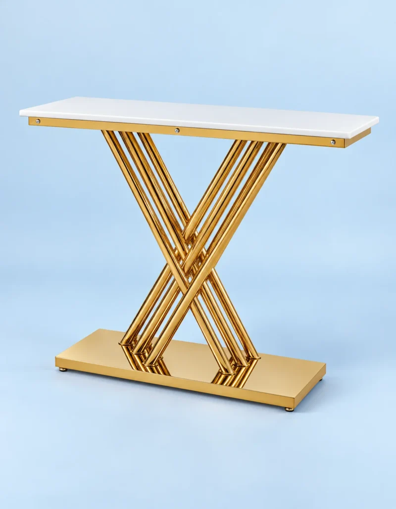 Modern rectangular white marble console table with sculptural gold stainless steel X-shaped rod base against a light blue background.
