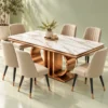 Rectangular white marble dining table with rose-gold double loop base and six cream upholstered chairs against a light green background.