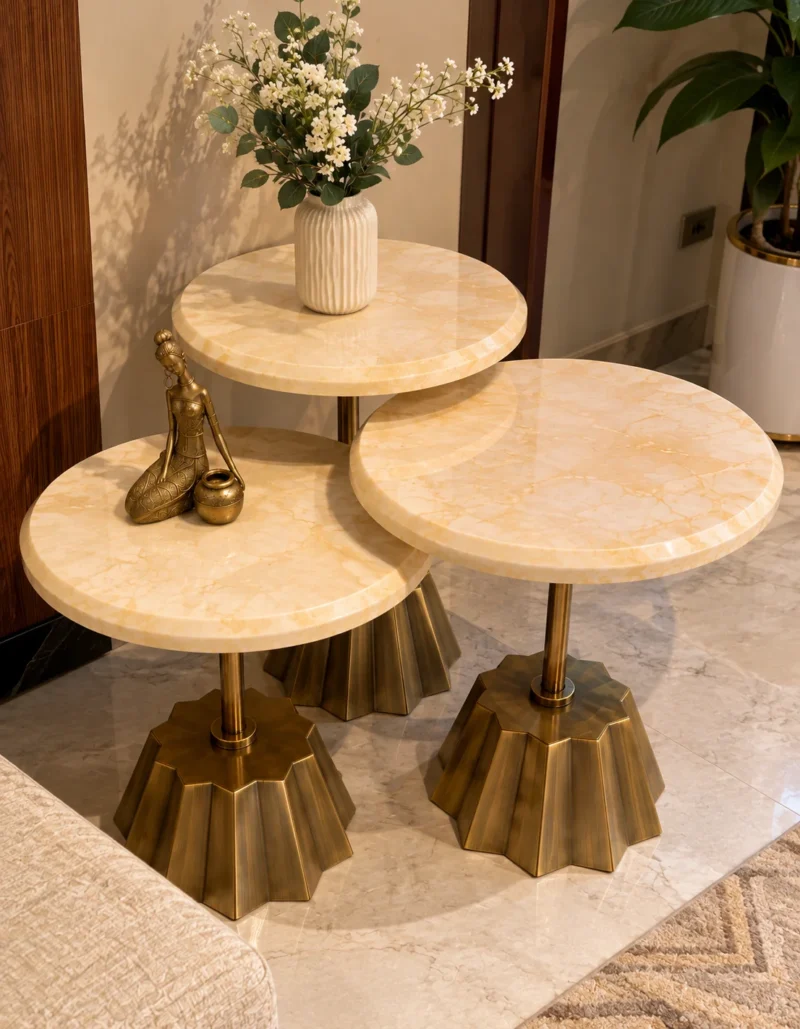 Three round cream marble side tables with fluted gold stainless steel bases