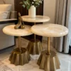 Modern marble side table set of three beside sofa and curtains