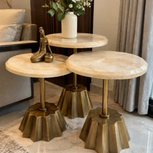 Modern marble side table set of three beside sofa and curtains