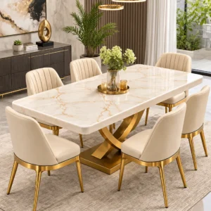 Gold stainless steel dining table with white marble top and curved X pedestal
