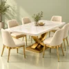 Designer marble dining table with curved gold X base and cream dining chairs