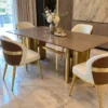 Brown marble dining table with gold cylindrical stainless steel base