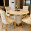 Round marble dining table with gold fluted pedestal and chairs