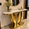 Gold marble console table with wing inspired base in entryway
